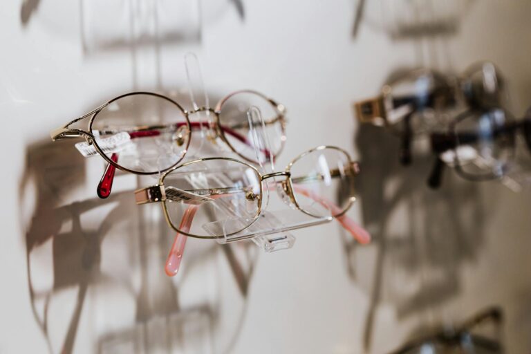 A close-up of stylish eyewear on display highlighting reflections and shadows.
